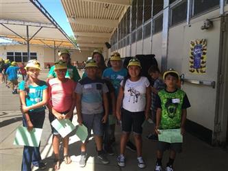 group of students outside with hard hats