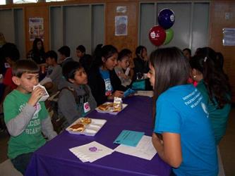 students eating together at lunch with a purple table cloth